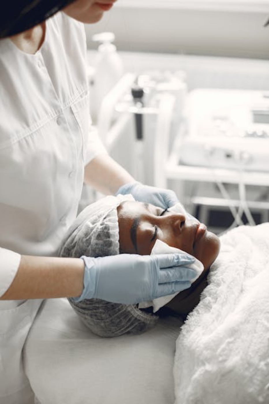 Facial treatment in progress with a towel wrap and hydrating application